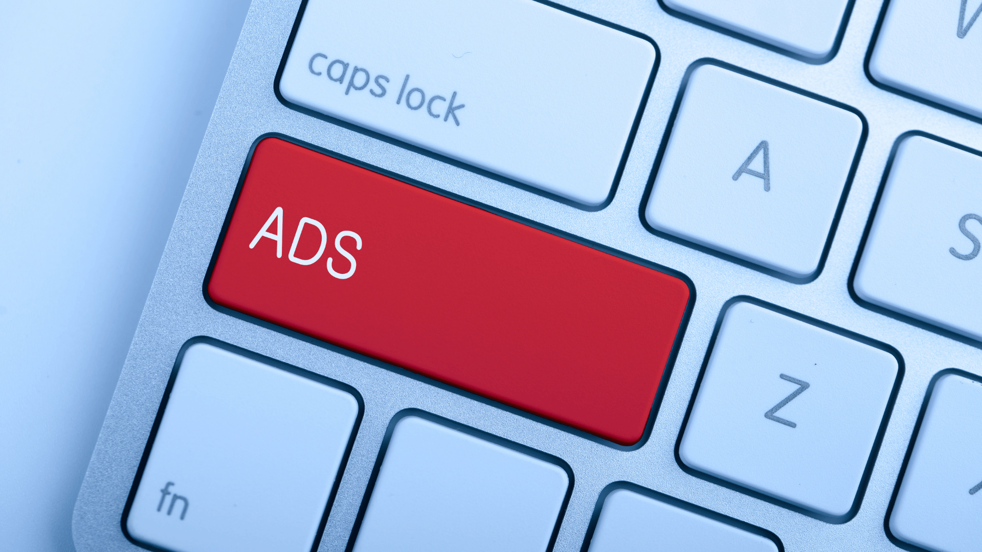 A red "ADS" key on a keyboard—symbolizing Bing Ads vs Google Ads in online advertising.